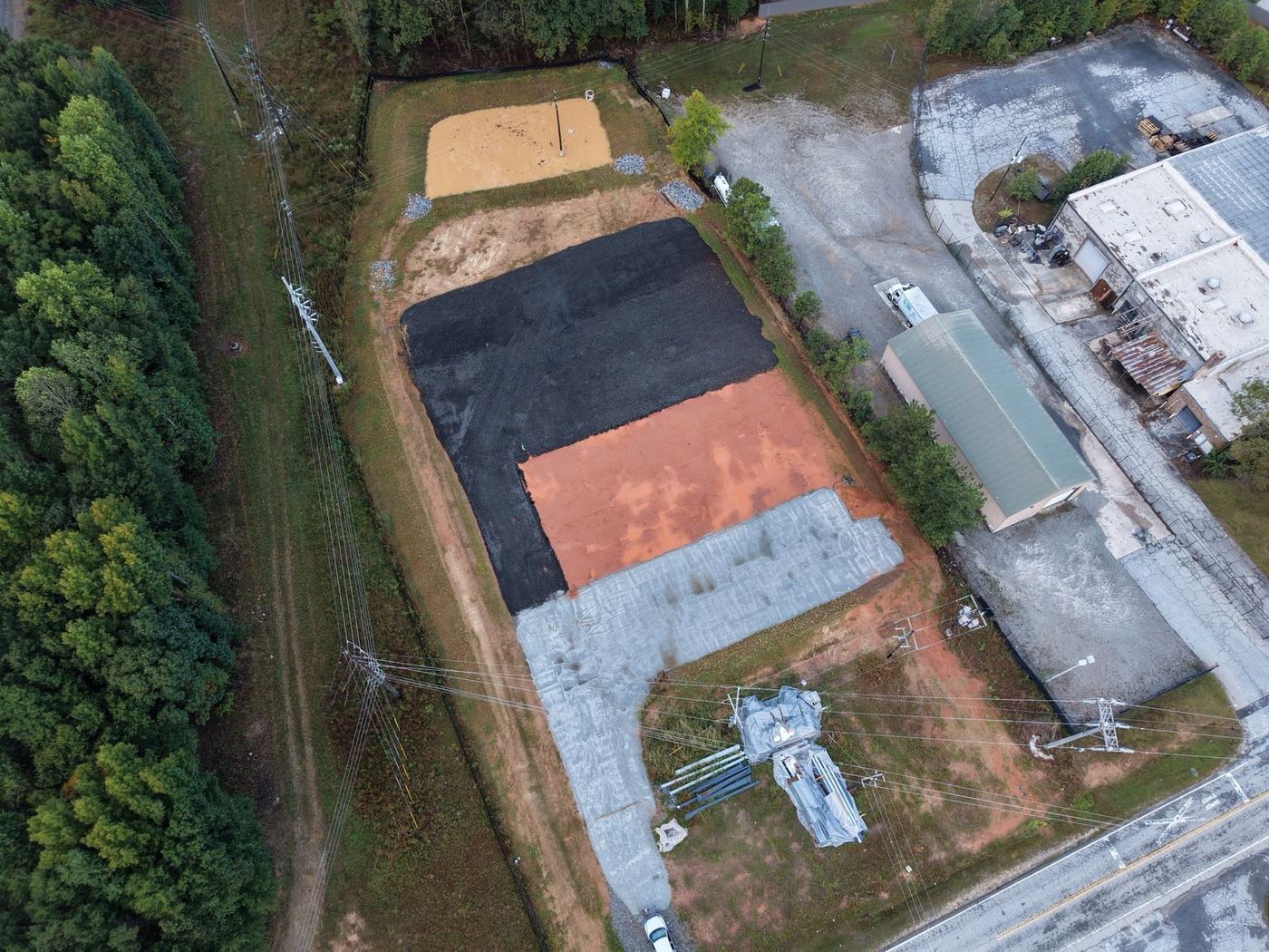 Aerial view of a finished pad with stone base and asphalt