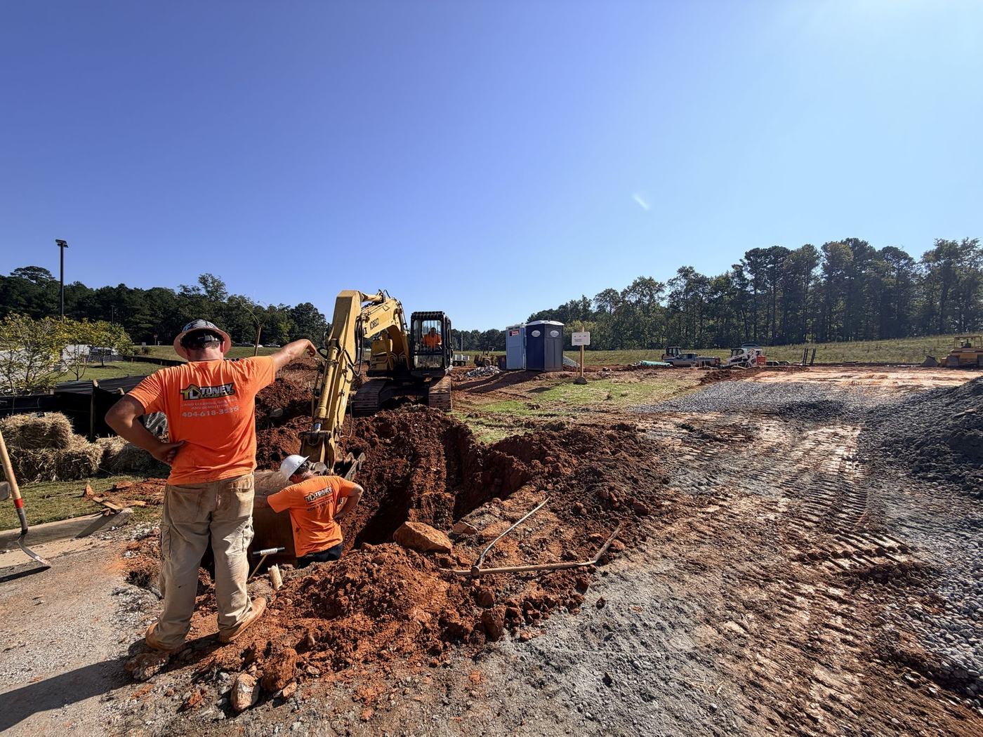 Toney Louis crew installing an underground utility structure in a trench